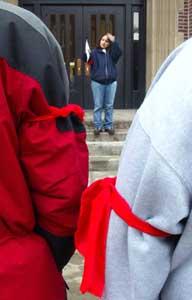 Cindy Gillis reads a statement of protest to a group of supporters of American Indian law students whose request to have a traditional drum group perform an honor song at graduation for the UND School of Law was denied by the university.